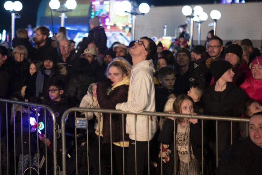 Crowds behind safety barrier watching the bonfire night display at Perth's South Inch in 2022
