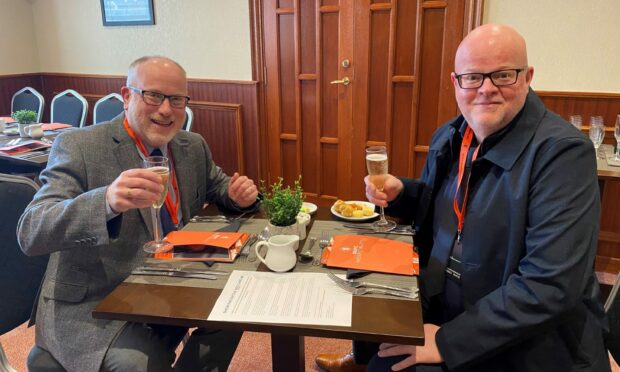 Brian Stormont, left, and Ian start their day off with some Champagne and canapes.