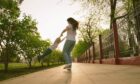 woman happily lifts and circles child around