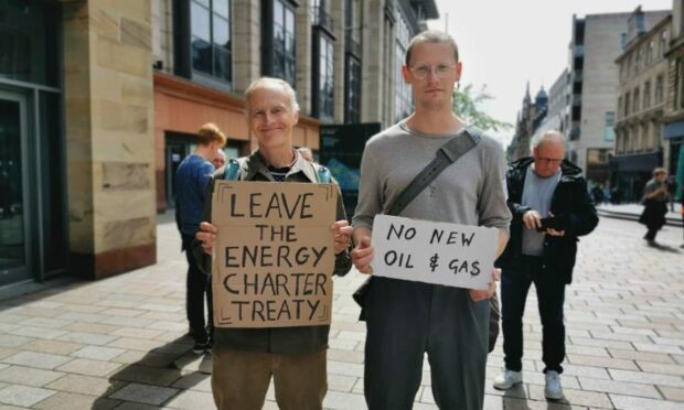 Adrian Johnson alongside his son, Dan Johnson, at a recent protest. Image: Adrian Johnson/Global Justice Now Scotland