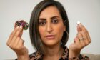 TV's Dr Punam Krishan holding a button battery from a cheap toy and strong magnetic toy. Both can cause serious injury if swallowed. Image: Paul Chappells/Child Accident Prevention Trust