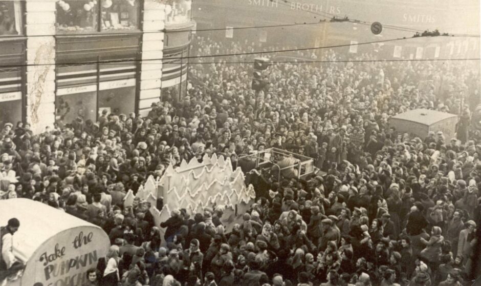 Sepia photo shows thousands of people outside the GL Wilson department store in Dundee, awaiting the arrival of Santa Claus.