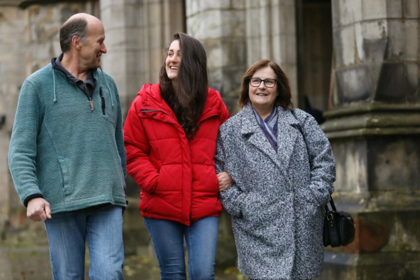 Amy, pictured walking with her parents, is grateful for her parents' "amazing support" as she journeys towards her eating disorder recovery.  Image: Gareth Jennings/DC Thomson.