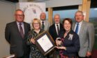 Lorraine Young of Carnoustie Memories accepts the award from Lord Lieutenant Pat Sawers with the committee of Archie Leiper, David Taylor, Craig Murray and Ed Oswald. Image: Gareth Jennings/DC Thomson