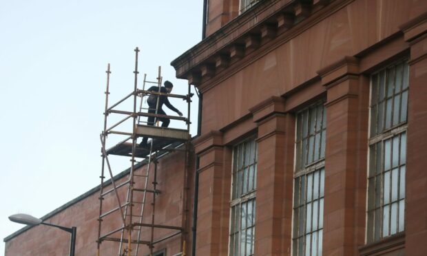 One of the youths at the top of the scaffolding on Euclid Crescent. Image: DC Thomson.