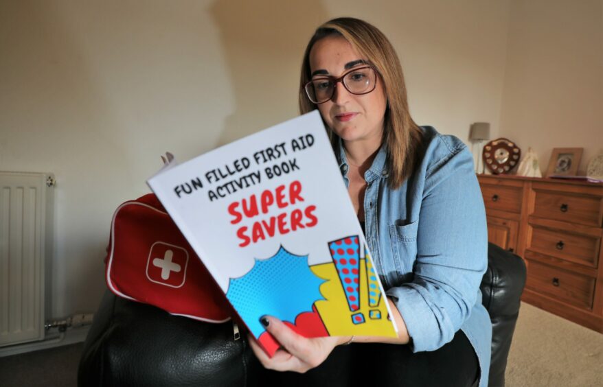 Louise Tyrrell from Carnoustie with her new first aid book for children, "Super Savers".