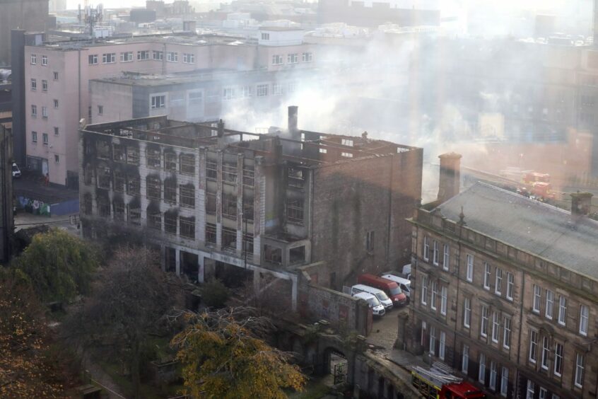 photo shows the smouldering remains of the building the morning after the fire.