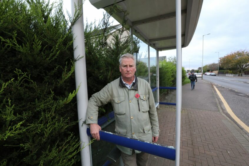 photo shows Counciillor Craig Duncan at a vandalised bus stop on Nursery Road Broughty Ferry. 