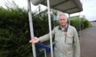 Councillor Craig Duncan at a smashed bus shelter in Broughty Ferry. Image: Gareth Jennings, DC Thomson.
