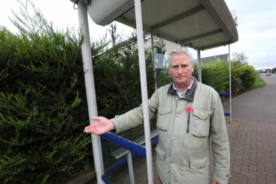 Councillor Craig Duncan at a smashed bus shelter in Broughty Ferry. Image: Gareth Jennings, DC Thomson.
