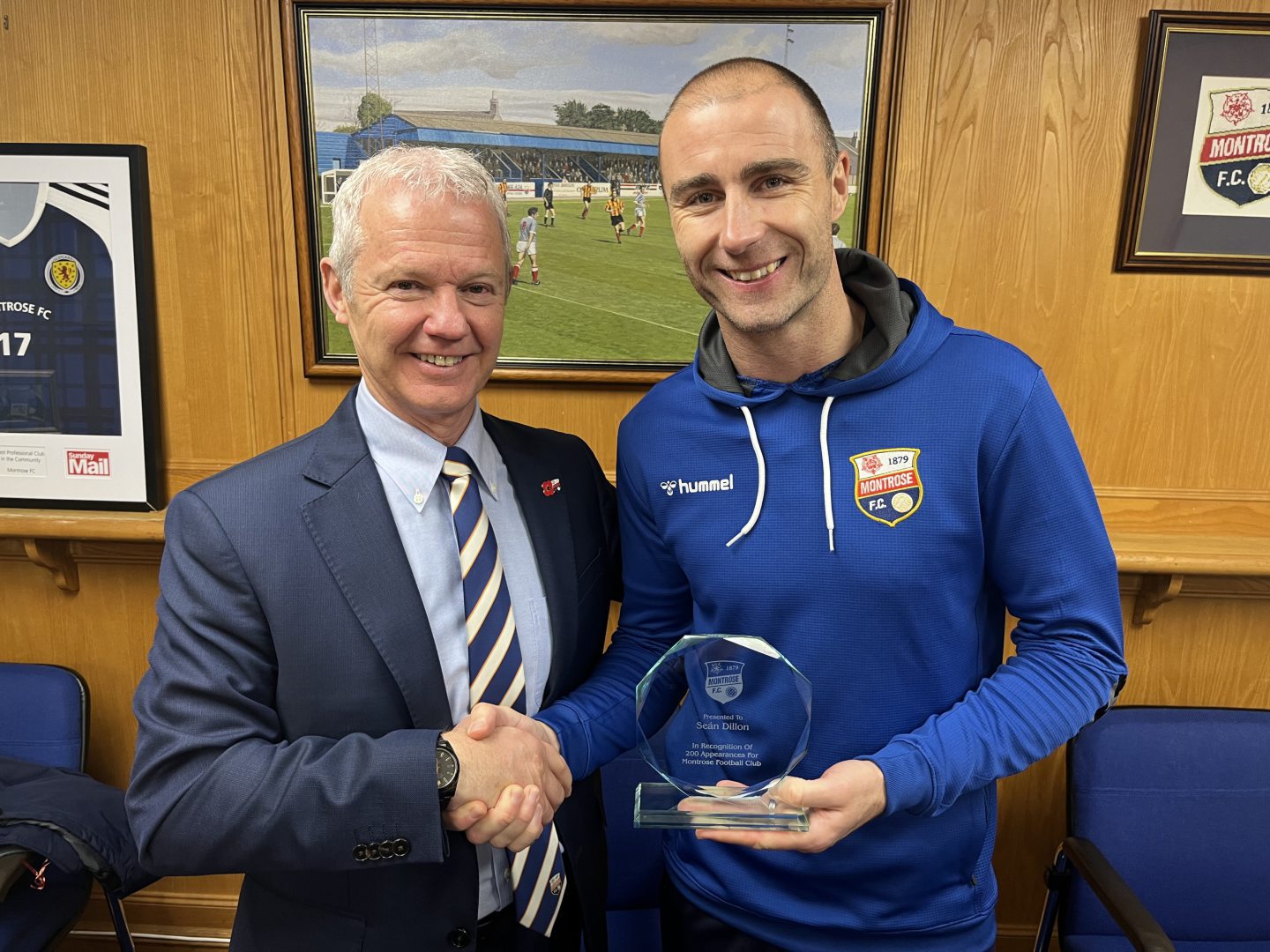 Montrose chief executive Peter Stuart presents Sean Dillon with a trophy to mark 200 appearances for the club. Image: Montrose FC