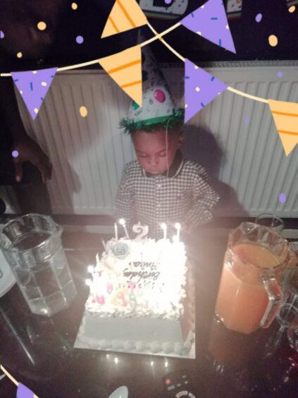 photo shows two year-old Awaab Ishak blowing out candles on a birthday cake,