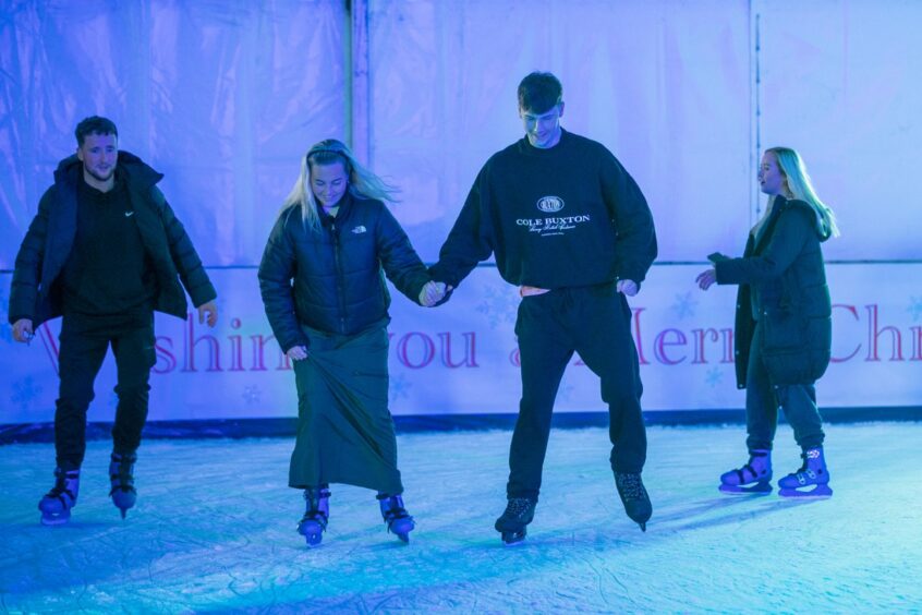 Holding hands for balance on the ice rink. Image: Kim Cessford/DC Thomson