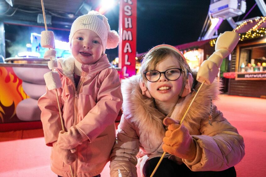 Sophie and Fallon Taylor - aged 2 and 9 - enjoy some marshmallows. Image: Kim Cessford/DC Thomson