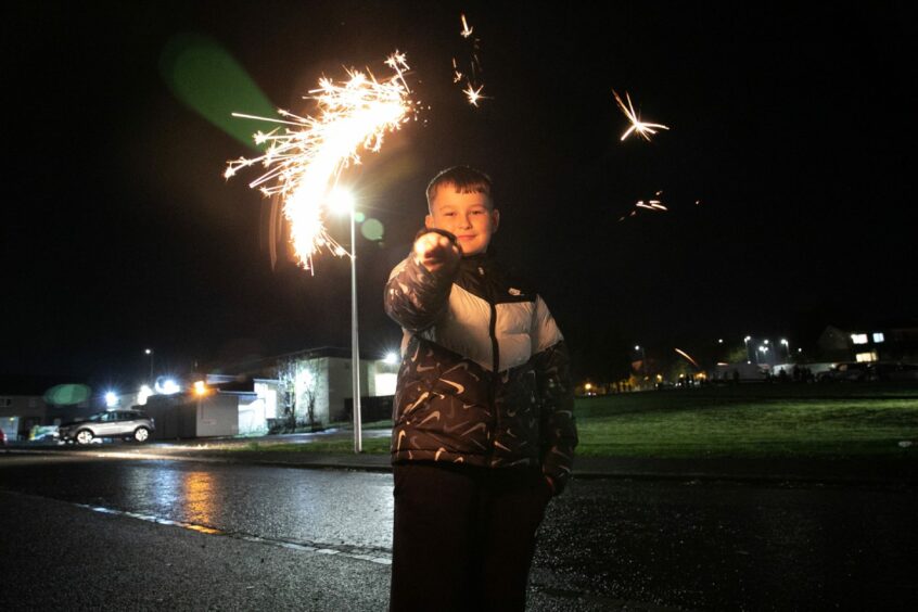 Layton Forbes (10) with a sparkler outside Nine Maidens. Image: Kim Cessford/DC Thomson.