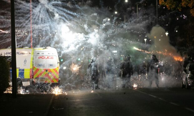 Pyrotechnics and bricks were lobbed at police officers responding to the chaos in Kirkton