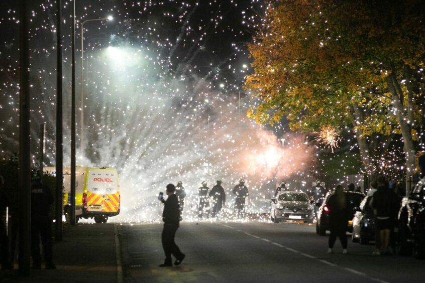 Fireworks go off near police as trouble flares in Kirkton on Halloween. Image: Kim Cessford/DC Thomson.