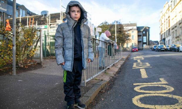 Liam McNaughton outside Glebelands Primary School on Baffin Street, where he was knocked down. Image: Kim Cessford/DC Thomson.