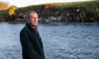 Robert Kellie beside the landfill pollution at the River Ericht. Image: Kim Cessford/DC Thomson.