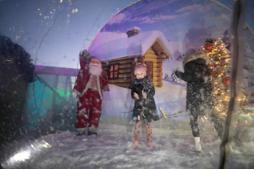 Children enjoy the snow globe at Dundee Winterfest event in 2021