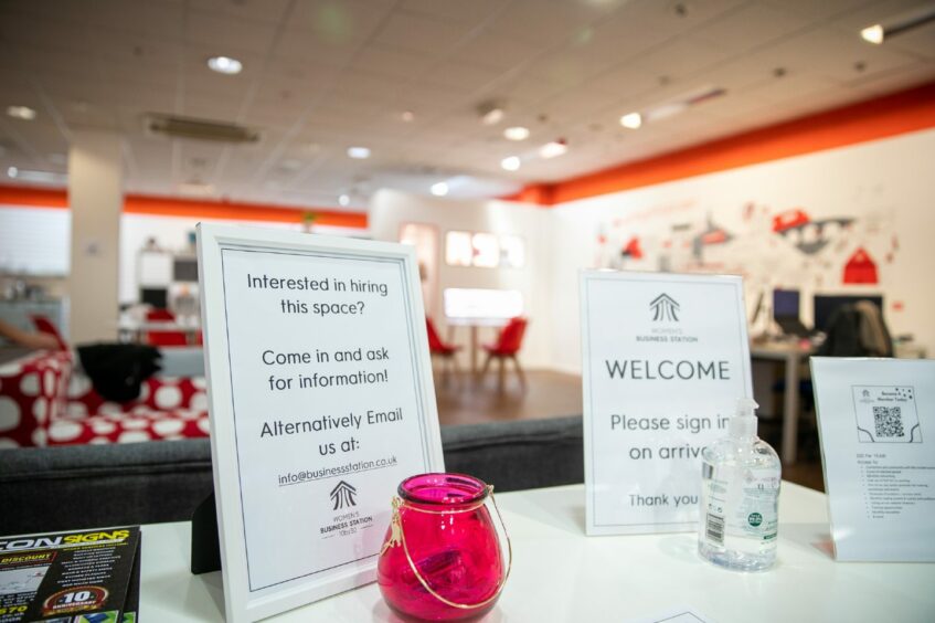 Photo shows a table inside the Business station with a notice which reads 'Interested in hiring this space? Come in and ask for information.'