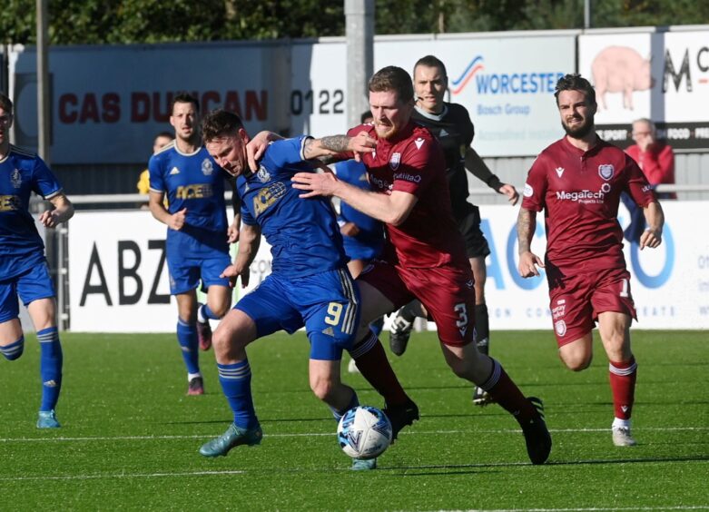 Colin Hamilton and Mitch Megginson tussle for the ball at the Balmoral Stadium last month. Image: DC Thomson/Kenny Elrick