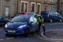 Police officers were positioned at entrances to streets near Downfield Primary to educate and warn drivers of the new restrictions. Image: Kenny Smith/ DC Thomson