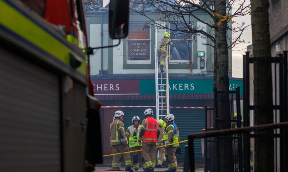 Firefighters outside Stuart's during the Leven fire