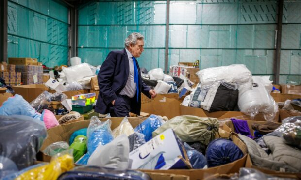 Mr Brown surveys tonnes of  Big Hoose donations in the Lochgelly warehouse.  Image: Kenny Smith/ DC Thomson.
