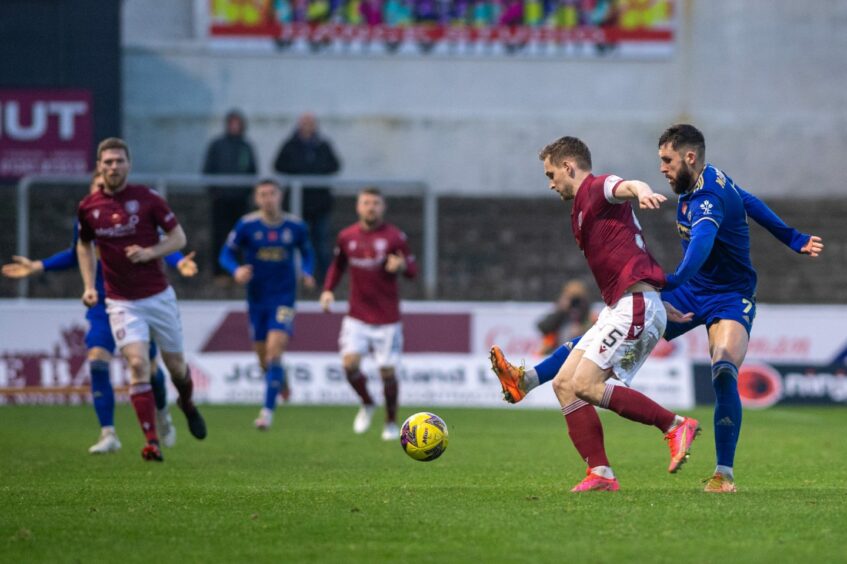 Arbroath captain Thomas O'Brien holds off Cove's Gerry McDonagh. Image: Kami Thomson/DC Thomson