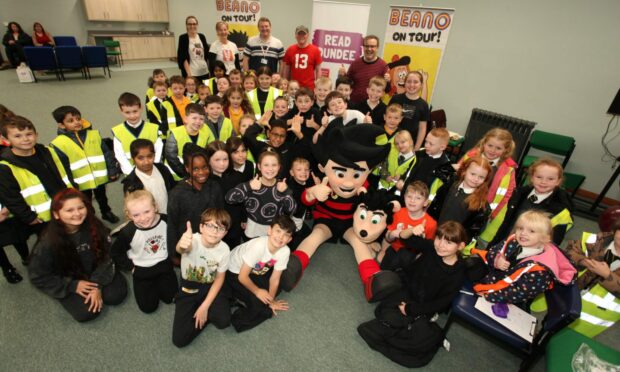 Dennis and Gnasher with children from SS Peter and Paul Primary School, Beano's Mike Stirling and Craig Graham and the National Literacy Trust Read Dundee team. Image: Dundee City Council.