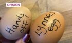 photo shows two eggs with the words 'hands off' and 'Lynne's egg' written on them
