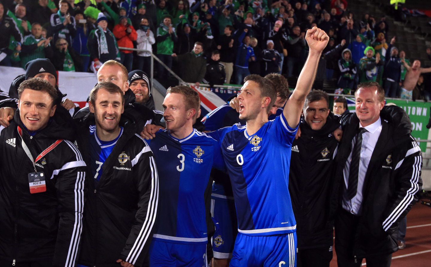 Michael O'Neill celebrates with his Northern Ireland team after a win over Mixu Paatelainen's Finland in Euro qualification. Image: PA