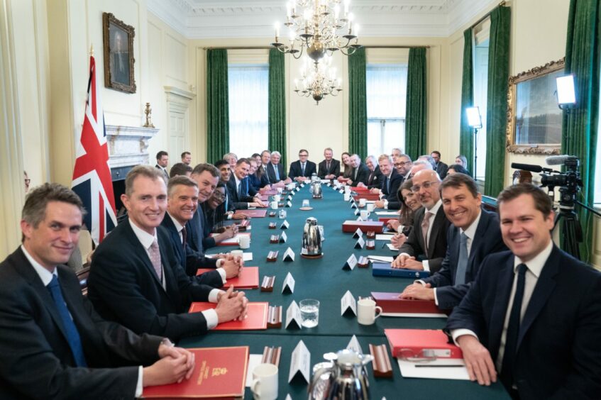 photo shows Gavin Williams and colleagues seated around the cabinet table in Downing Street.
