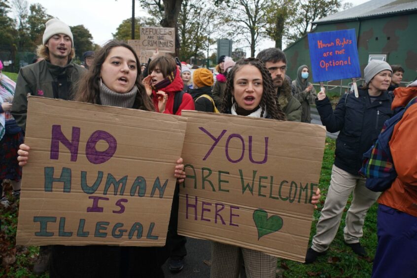 Protesters outside the Manston immigration short-term holding facility in Thanet, Kent, holding cardboard placards saying 'No human is illegal' and 'You are welcome here'. Image: Gareth Fuller/PA Wire