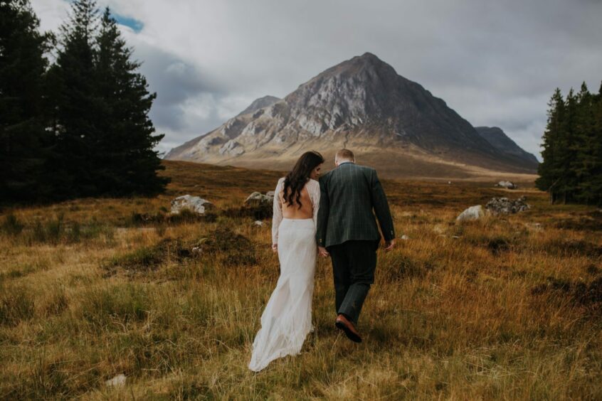 Couple poses in stunning scenery for wedding portraits. 