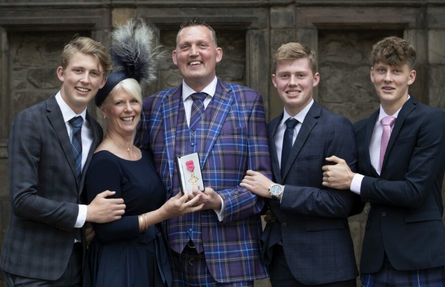 photo shows Doddie Weir, with wife Kathy and their sons Hamish, Ben and Angus, after he received his OBE.