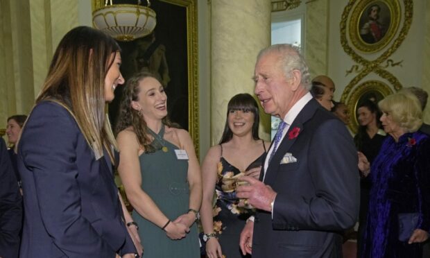 King Charles III meets Eve Muirhead and her gold medal-winning team-mates. Image: PA.