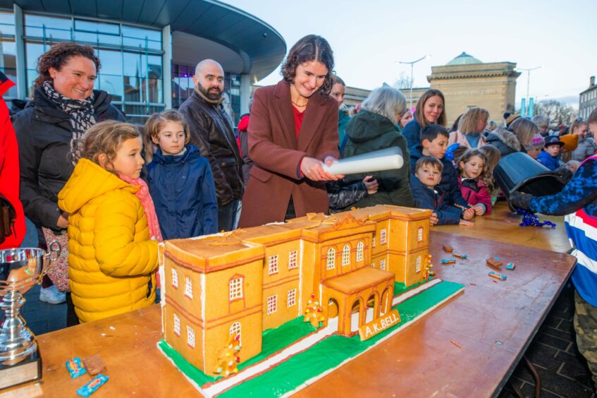 Katherine Burrows smashes her AK Bell Library cake