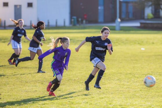 Dundee shirts will soon be seen in the girl's game - here St John's RC High School play in dark blue in 2020 (Image: Steve MacDougall/DCT)