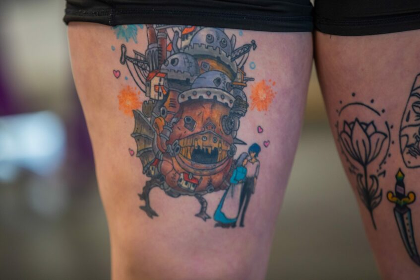 Close up detail of colourful thigh tattoos on Curves assistant manager Beck Fairlie. 
