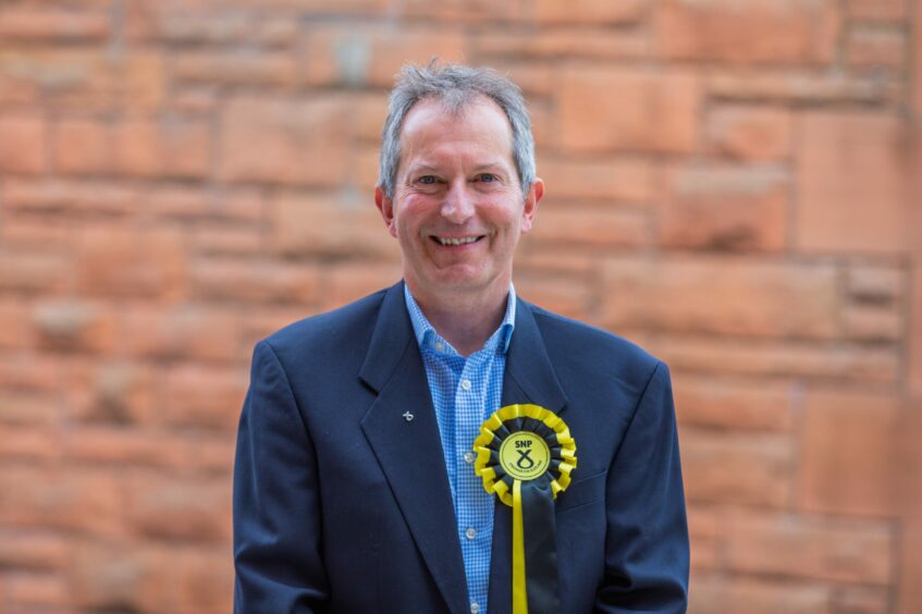 Jack Welch in suit, wearing SNP councillor