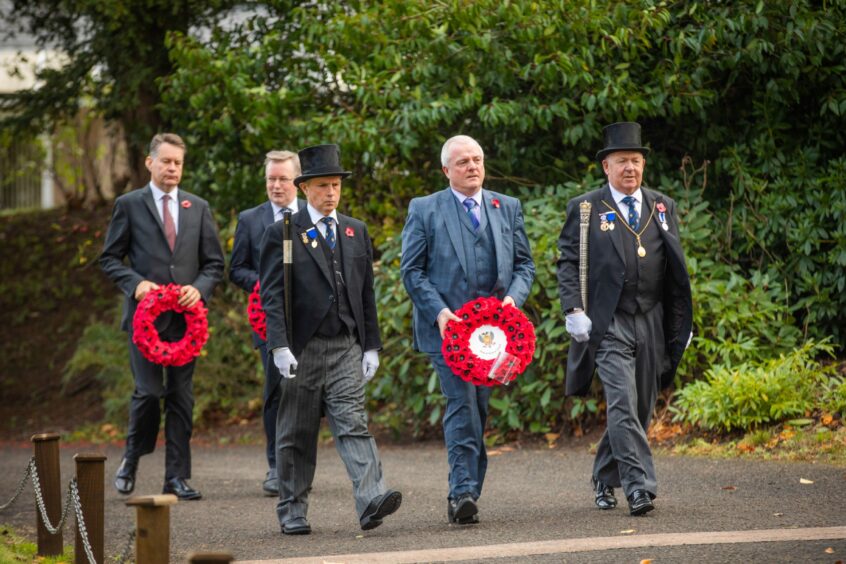 High Constables of Perth with other dignitaries carrying poppy wreaths at remembrance service