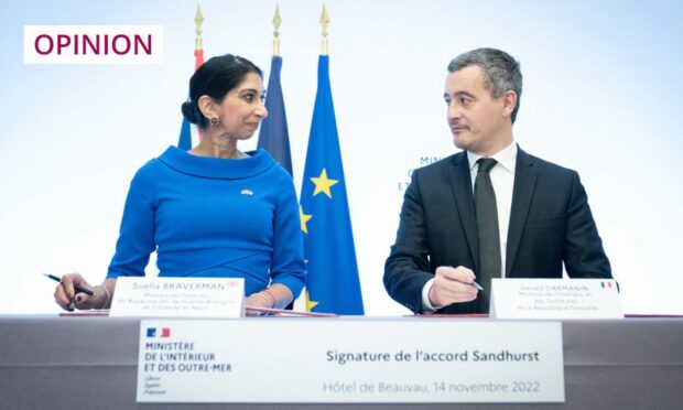 photo shows Suella Braverman and the French Interior Minister Gerald Darmanin signing an agreement aimed at tackling the small boats crisis in the Channel.