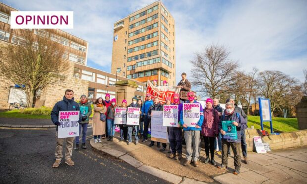 photo shows workers holding placards on a picket line outside Dundee University.
