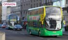 Photo shows two buses being driven through Dundee city centre.