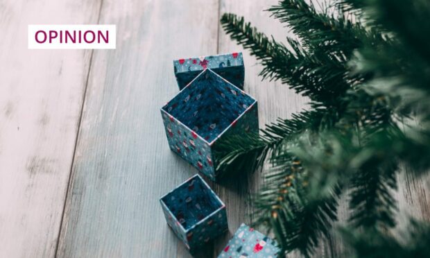 photo shows empty gift boxes under a Christmas tree.