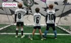 Photo shows Martel Maxwell's three sons pictured from behind, wearing football tops with their names and ages.