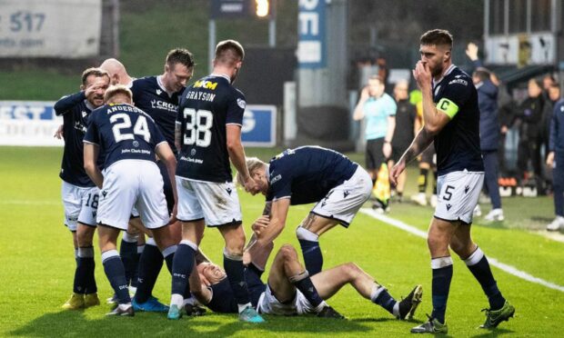 Cammy Kerr is mobbed by team-mates after his winner against Partick Thistle