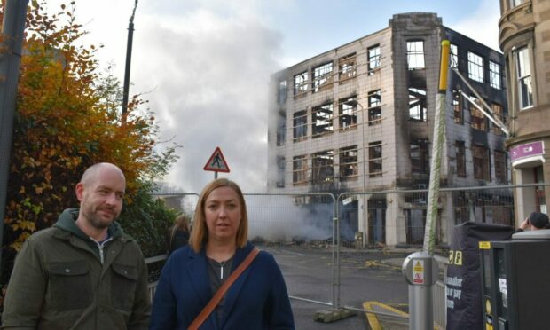Michael Dix and his wife Eileen standing next to the remnants of the fire on Barrack Street. Image: Amie Flett/DC Thomson.